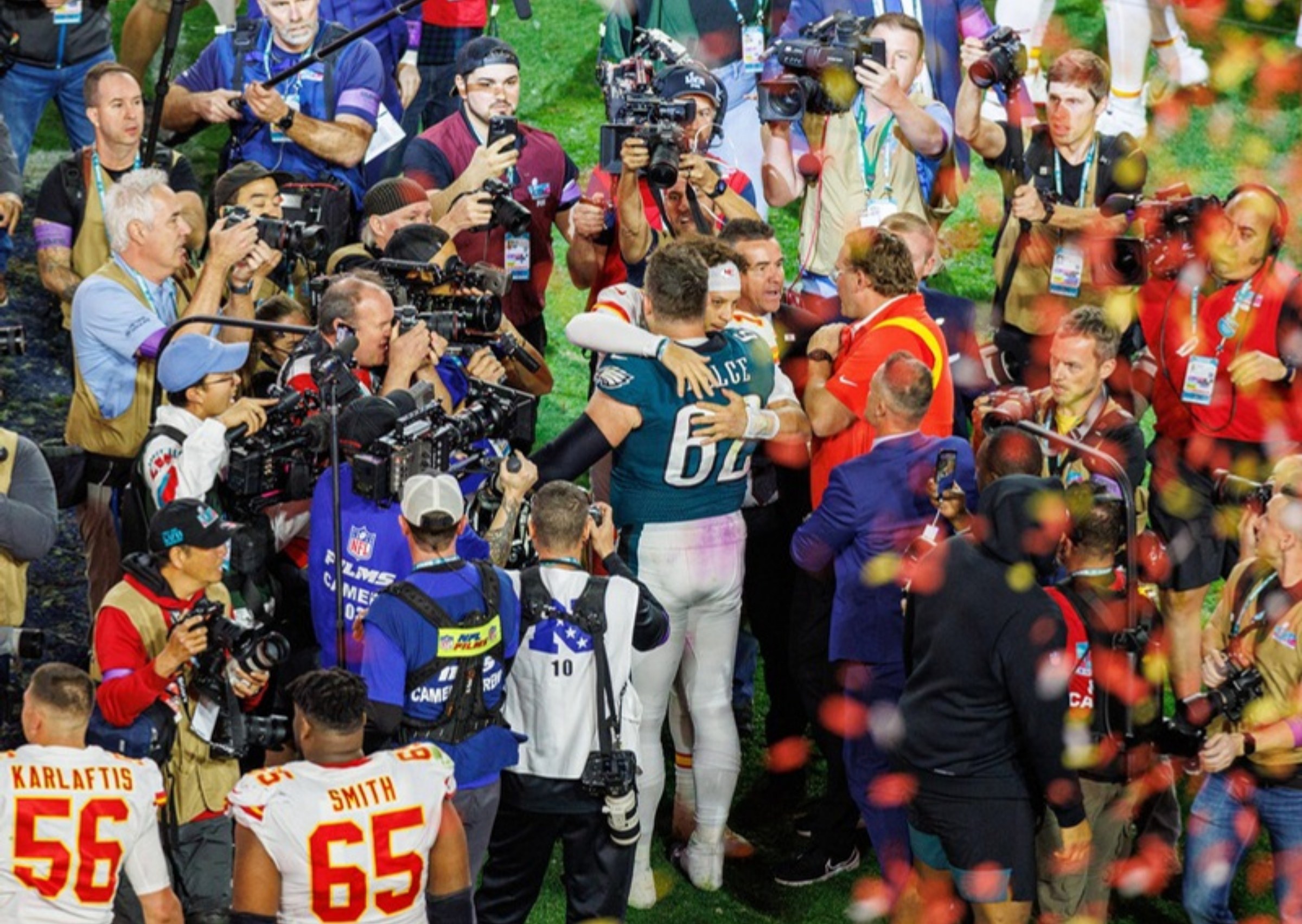 Spieler von Chiefs und Eagles nach dem Super Bowl LVII im Konfettiregen, umringt von Fotografen und Kameraleuten